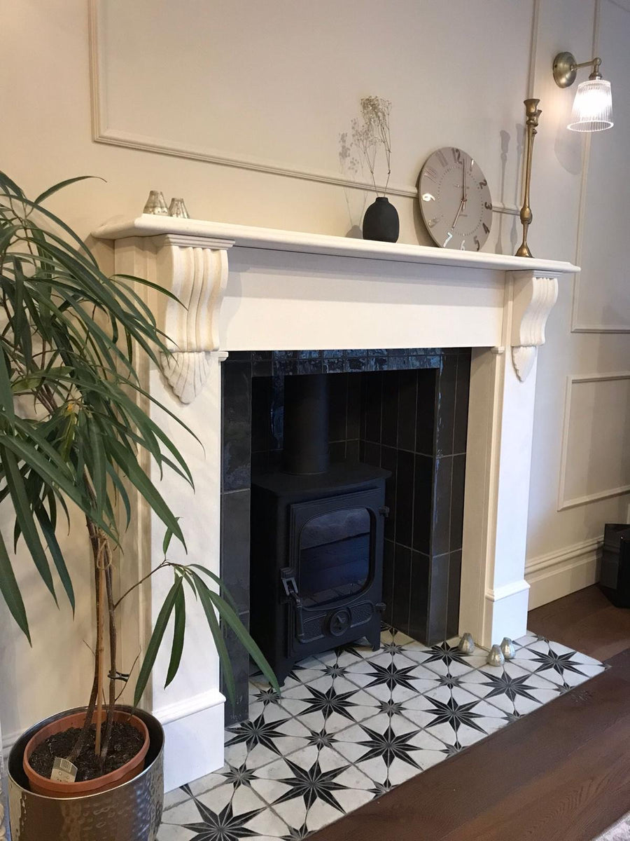 Black Star tiles on the hearth of a fireplace