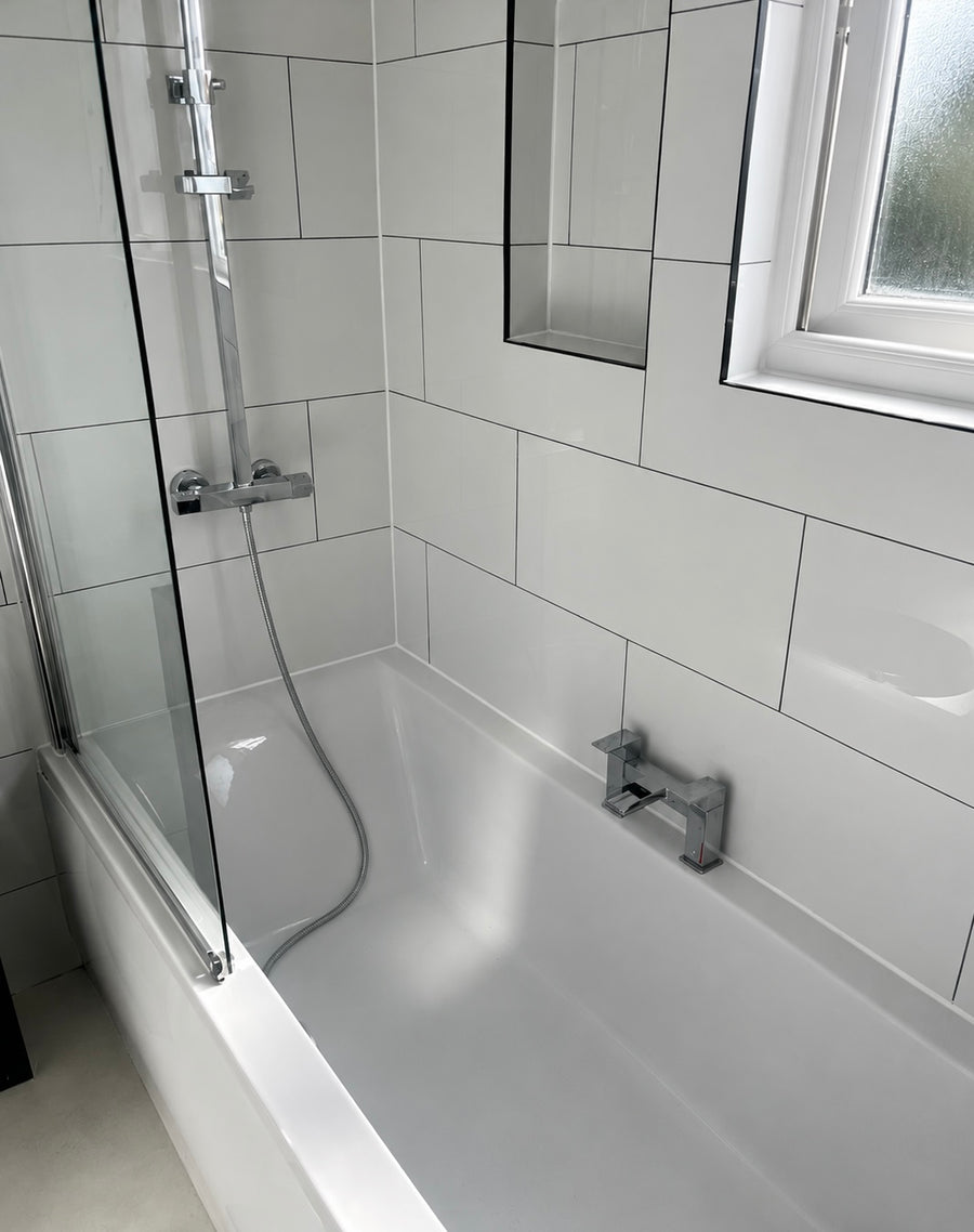 White polished tiles in a bathroom with dark grey grout