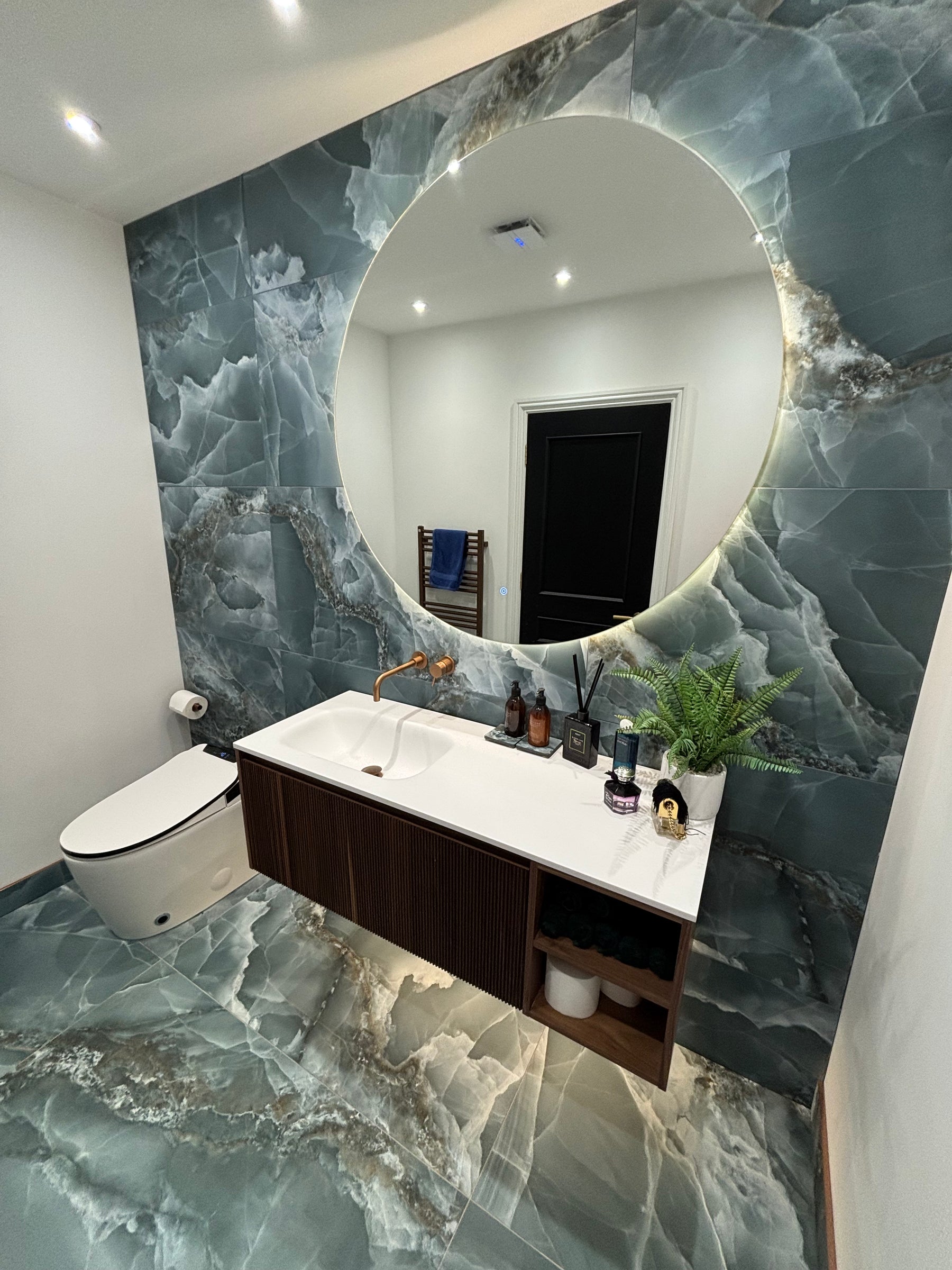 WC with Green onyx tiles in matt finish on walls and floor