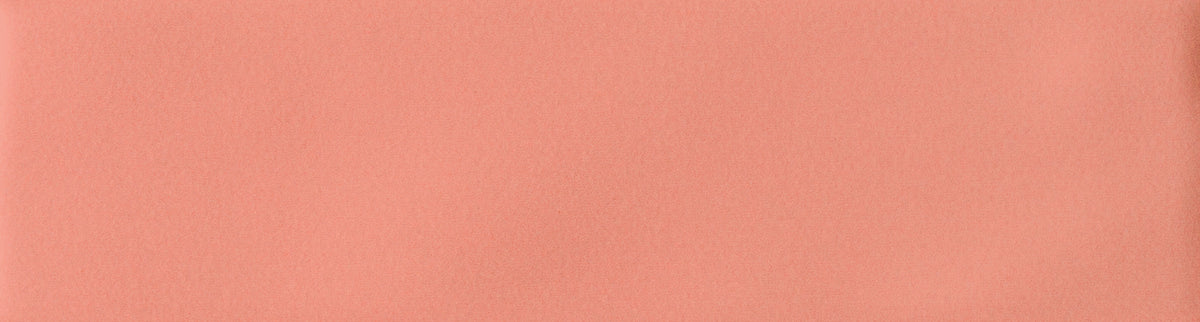 A close-up color swatch of a solid warm peach-pink textured material.