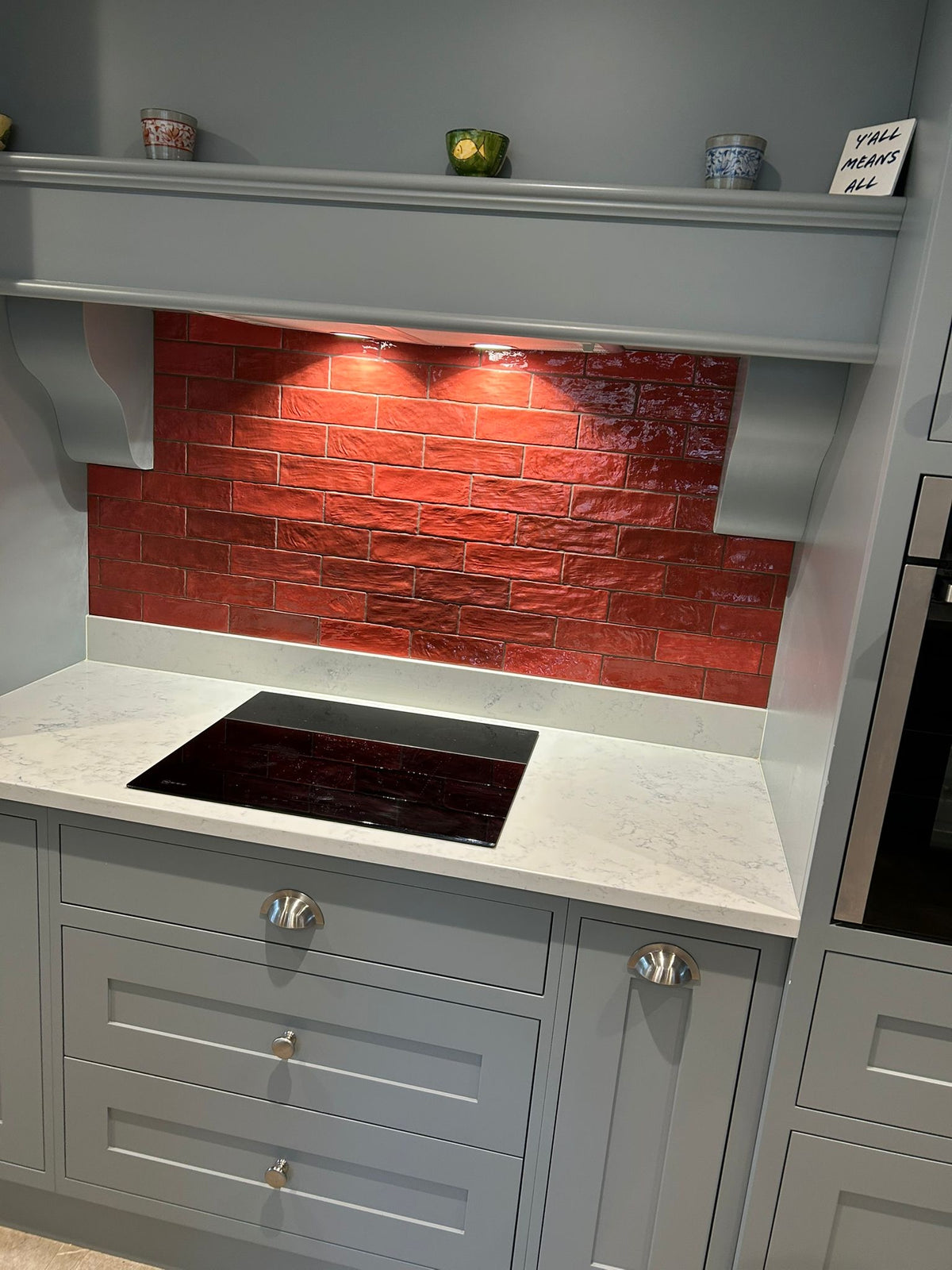 Red zellige style ceramic tiles on kitchen splashback 